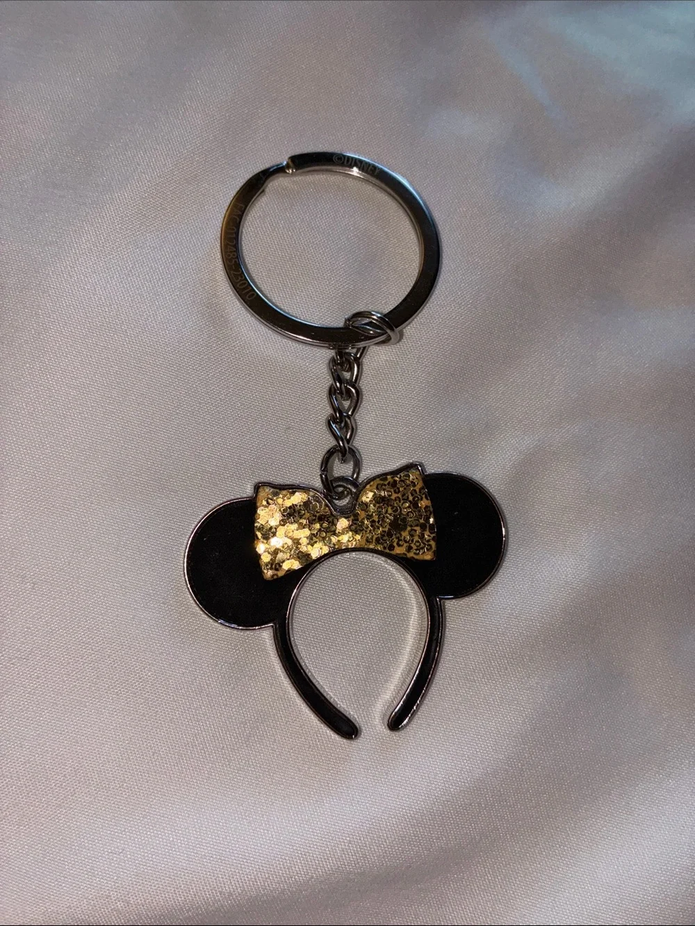 Disney Black Minnie Ear Keychain with Gold Glitter Bow